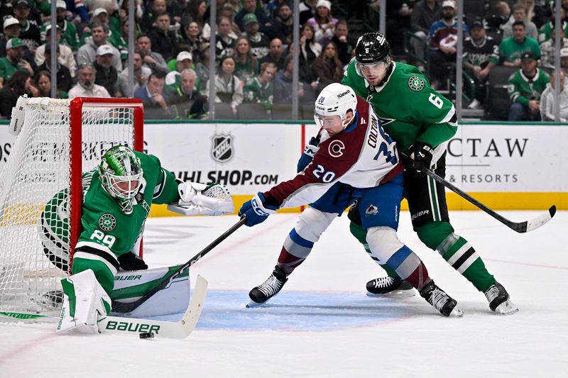 Mar 6, 2026; Dallas, Texas, USA; Dallas Stars goaltender Jake Oettinger (29) blocks a shot by Colorado Avalanche center Ross Colton (20) as defenseman Lian Bichsel (6) looks on during the first period at the American Airlines Center. Mandatory Credit: Jerome Miron-Imagn Images