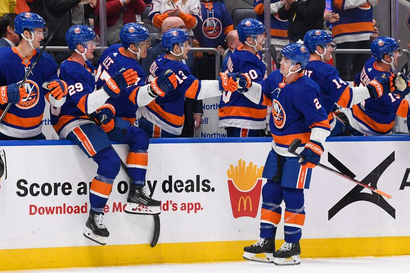 Dec 5, 2023; Elmont, New York, USA; New York Islanders defenseman Mike Reily (2) celebrates his goal against the San Jose Sharks with the New York Islanders bench during the third period at UBS Arena. Mandatory Credit: Dennis Schneidler-USA TODAY Sports