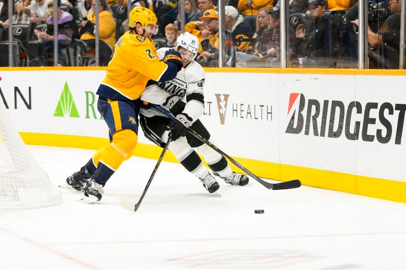 Nov 4, 2024; Nashville, Tennessee, USA;  Nashville Predators defenseman Luke Schenn (2) checks Los Angeles Kings left wing Warren Foegele (37) during the second period at Bridgestone Arena. Mandatory Credit: Steve Roberts-Imagn Images