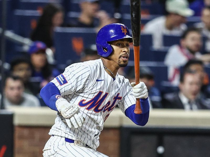 May 30, 2024; New York City, New York, USA; New York Mets shortstop Francisco Lindor (12) hits an RBI double in the seventh inning against the Arizona Diamondbacks at Citi Field. Mandatory Credit: Wendell Cruz-USA TODAY Sports