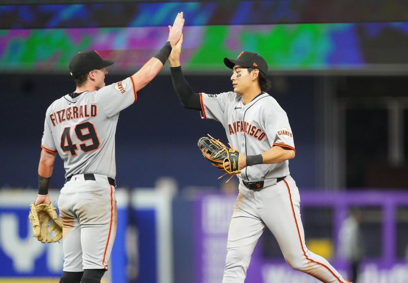 May 30, 2025; Miami, Florida, USA;  San Francisco Giants second baseman Tyler Fitzgerald (49) and center fielder Jung Hoo Lee (51) celebrate a win against the Miami Marlins at loanDepot Park. Mandatory Credit: Jim Rassol-Imagn Images