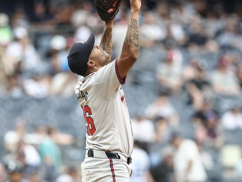 Jun 23, 2024; Bronx, New York, USA;  Atlanta Braves pitcher Raisel Iglesias (26) celebrates after recording save and defeating the New York Yankees 3-1 at Yankee Stadium. Mandatory Credit: Wendell Cruz-USA TODAY Sports