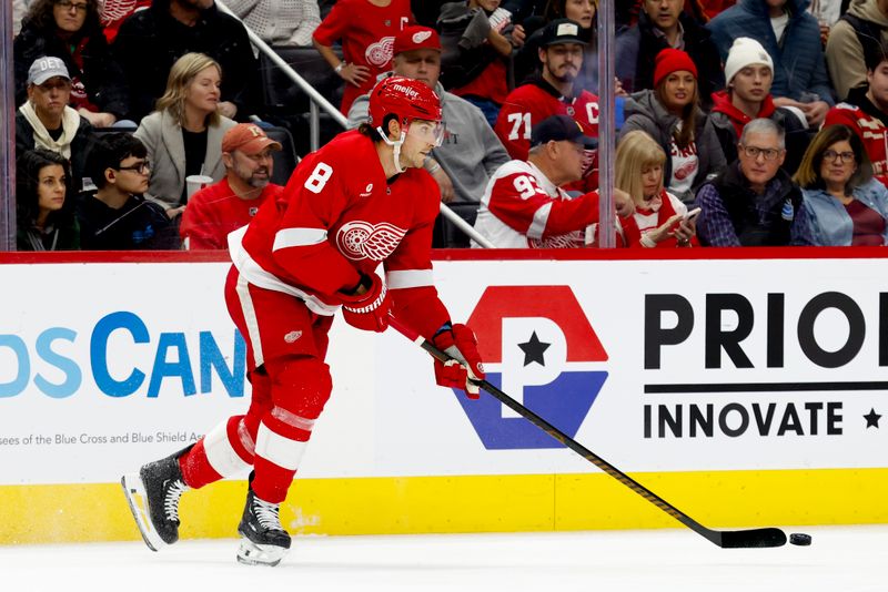 Dec 1, 2024; Detroit, Michigan, USA;  Detroit Red Wings defenseman Ben Chiarot (8) skates with the puck in the first period against the Vancouver Canucks at Little Caesars Arena. Mandatory Credit: Rick Osentoski-Imagn Images