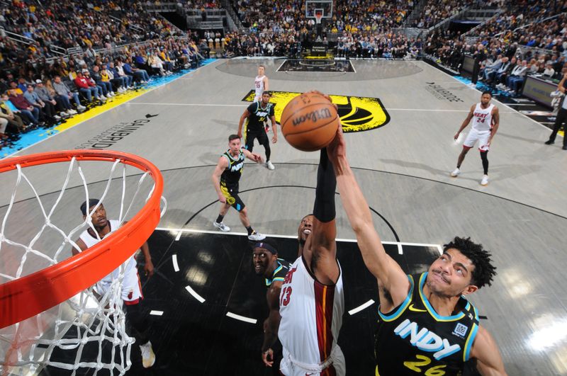 INDIANAPOLIS, IN - APRIL 7: Ben Sheppard #26 of the Indiana Pacers and Bam Adebayo #13 of the Miami Heat go up for the rebound during the game on April 7, 2024 at Gainbridge Fieldhouse in Indianapolis, Indiana. NOTE TO USER: User expressly acknowledges and agrees that, by downloading and or using this Photograph, user is consenting to the terms and conditions of the Getty Images License Agreement. Mandatory Copyright Notice: Copyright 2024 NBAE (Photo by Ron Hoskins/NBAE via Getty Images)