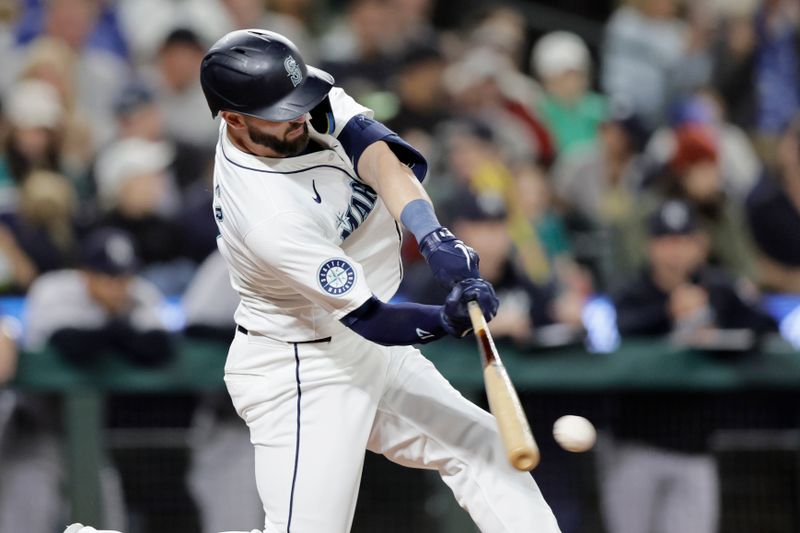 Sep 18, 2024; Seattle, Washington, USA; Seattle Mariners right fielder Mitch Haniger (17) hits a single against the New York Yankees during the fifth inning at T-Mobile Park. Mandatory Credit: John Froschauer-Imagn Images
