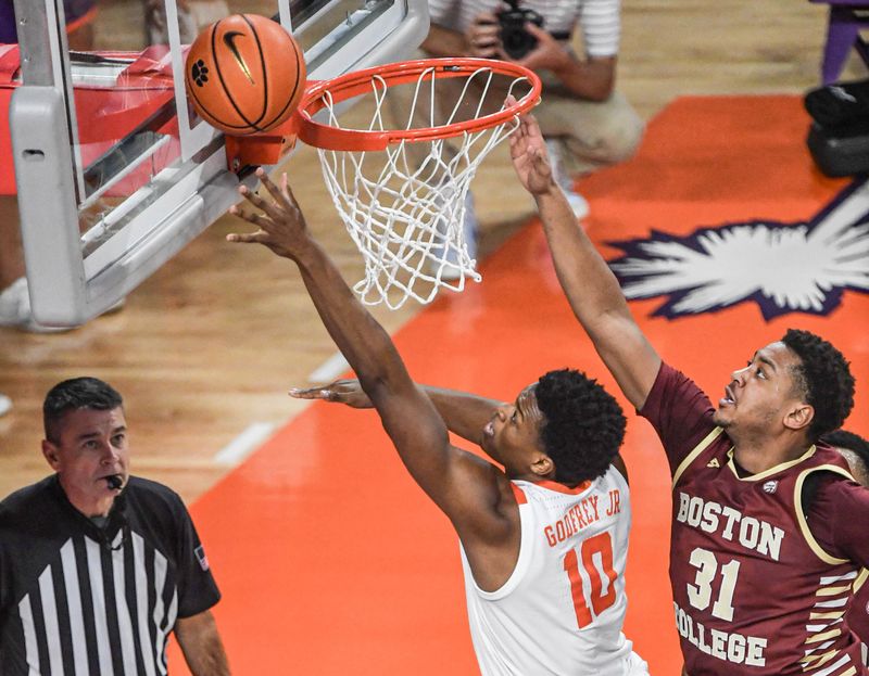 Jan 13, 2024; Clemson, South Carolina, USA; Clemson Tigers forward RJ Godfrey (10) scores against Boston College Eagles forward Elijah Strong (31) during the first half at Littlejohn Coliseum. Mandatory Credit: Ken Ruinard-USA TODAY Sports