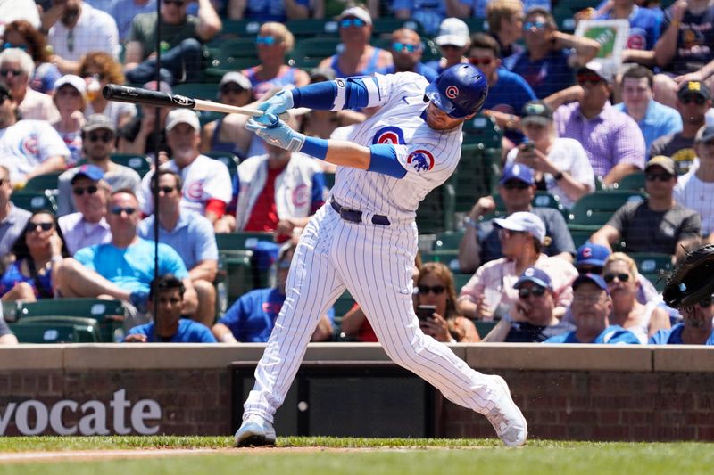 May 31, 2023; Chicago, Illinois, USA; Chicago Cubs left fielder Ian Happ (8) hits a one-run single against the Tampa Bay Rays during the first inning at Wrigley Field. Mandatory Credit: David Banks-USA TODAY Sports
