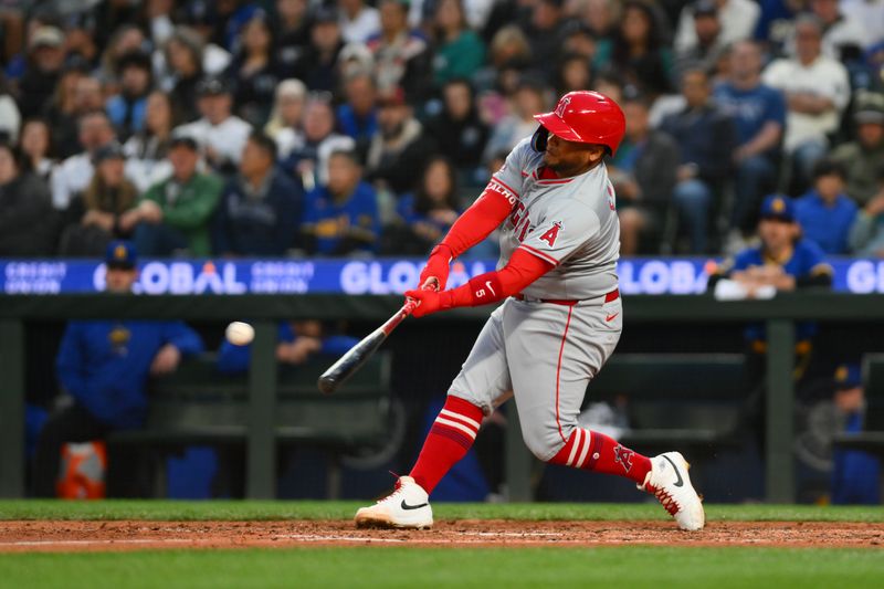 May 31, 2024; Seattle, Washington, USA; Los Angeles Angels first baseman Willie Calhoun (5) hits a double against the Seattle Mariners during the seventh inning at T-Mobile Park. Mandatory Credit: Steven Bisig-USA TODAY Sports