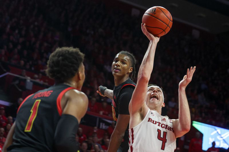 Jan 5, 2023; Piscataway, New Jersey, USA; Rutgers Scarlet Knights guard Paul Mulcahy (4) drives to the basket asMaryland Terrapins forward Julian Reese (10) and guard Jahmir Young (1) during the second half at Jersey Mike's Arena. Mandatory Credit: Vincent Carchietta-USA TODAY Sports