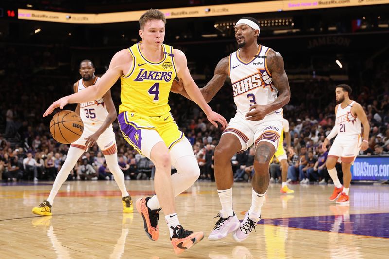 PHOENIX, ARIZONA - OCTOBER 17: Dalton Knecht #4 of the Los Angeles Lakers handles the ball against Bradley Beal #3 of the Phoenix Suns during the first half of the preseason NBA game at Footprint Center on October 17, 2024 in Phoenix, Arizona. NOTE TO USER: User expressly acknowledges and agrees that, by downloading and/or using this photograph, user is consenting to the terms and conditions of the Getty Images License Agreement.  (Photo by Christian Petersen/Getty Images)