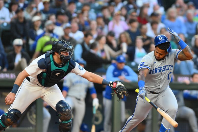 May 14, 2024; Seattle, Washington, USA; Kansas City Royals designated hitter Nelson Velazquez (17) avoids a tag by Seattle Mariners catcher Cal Raleigh (29) after striking out during the fifth inning at T-Mobile Park. Mandatory Credit: Steven Bisig-USA TODAY Sports