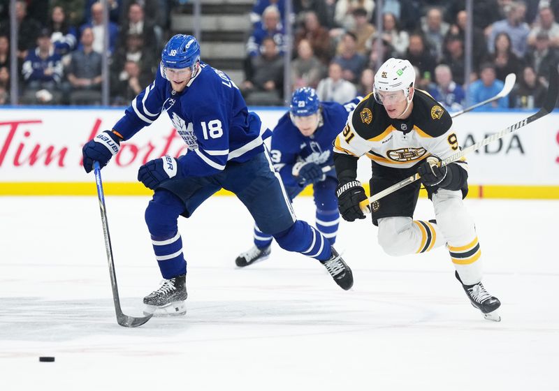 Nov 5, 2024; Toronto, Ontario, CAN; Toronto Maple Leafs center Steven Lorentz (18) and Boston Bruins defenseman Nikita Zadorov (91) chase done the puck during the third period at Scotiabank Arena. Mandatory Credit: Nick Turchiaro-Imagn Imagess