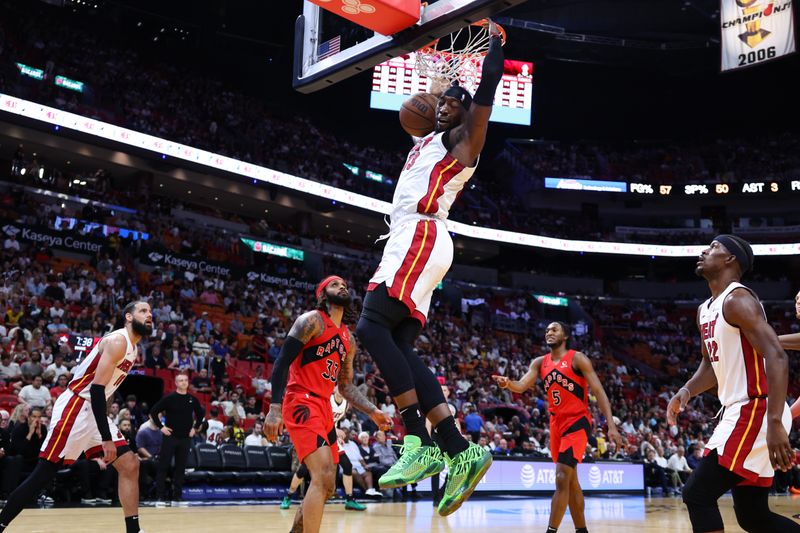 MIAMI, FLORIDA - APRIL 12: Bam Adebayo #13 of the Miami Heat dunks the ball against the Toronto Raptors during the first quarter of the game at Kaseya Center on April 12, 2024 in Miami, Florida. NOTE TO USER: User expressly acknowledges and agrees that, by downloading and or using this photograph, User is consenting to the terms and conditions of the Getty Images License Agreement. (Photo by Megan Briggs/Getty Images)