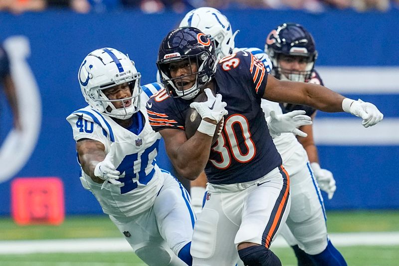 Chicago Bears running back Roschon Johnson (30) is pursued by Indianapolis Colts cornerback Jaylon Jones (40) during the first half of an NFL preseason football game in Indianapolis, Saturday, Aug. 19, 2023. (AP Photo/Darron Cummings)