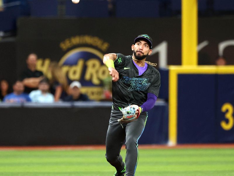 May 3, 2024; St. Petersburg, Florida, USA;  Tampa Bay Rays shortstop José Caballero (7) throws the ball to first base for  an out against the New York Mets during the third inning at Tropicana Field. Mandatory Credit: Kim Klement Neitzel-USA TODAY Sports