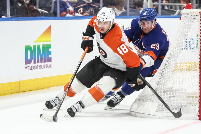 Jan 16, 2025; Elmont, New York, USA;  Philadelphia Flyers center Morgan Frost (48) and New York Islanders center Brock Nelson (29) battle for control of the puck in the second period at UBS Arena. Mandatory Credit: Wendell Cruz-Imagn Images