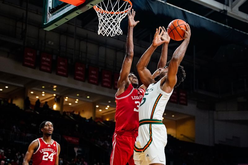 Feb 11, 2023; Coral Gables, Florida, USA; Miami (Fl) Hurricanes forward Norchad Omier (15) shoots over Louisville Cardinals forward Emmanuel Okorafor (34) during the second half at Watsco Center. Mandatory Credit: Rich Storry-USA TODAY Sports