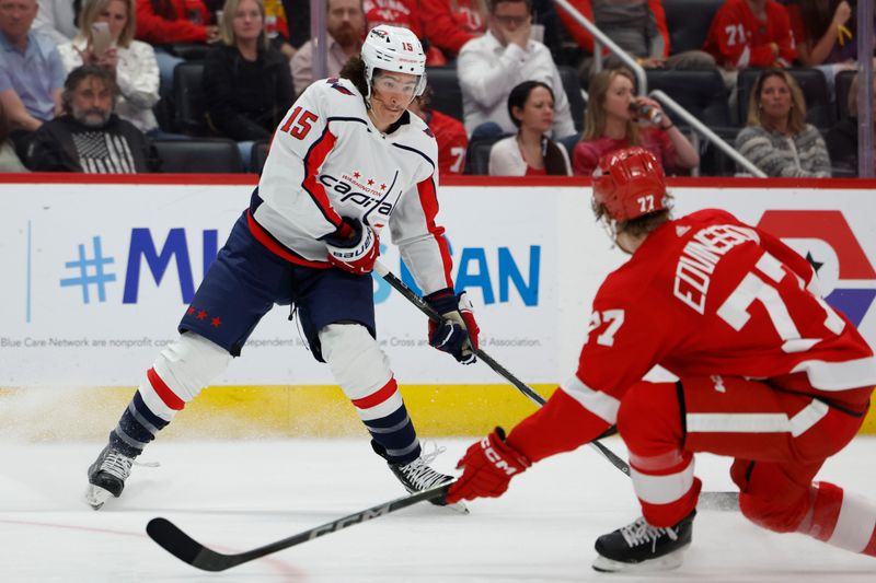 Apr 9, 2024; Detroit, Michigan, USA; Washington Capitals left wing Sonny Milano (15) skates with the puck defended by Detroit Red Wings defenseman Simon Edvinsson (77) in the third period at Little Caesars Arena. Mandatory Credit: Rick Osentoski-USA TODAY Sports