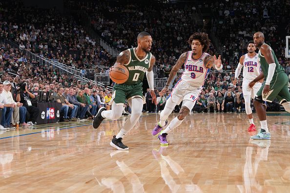 MILWAUKEE, WI - OCTOBER 26: Damian Lillard #0 of the Milwaukee Bucks drives to the basket during the game against the Philadelphia 76ers on October 26, 2023 at the Fiserv Forum Center in Milwaukee, Wisconsin. NOTE TO USER: User expressly acknowledges and agrees that, by downloading and or using this Photograph, user is consenting to the terms and conditions of the Getty Images License Agreement. Mandatory Copyright Notice: Copyright 2023 NBAE (Photo by Jesse D. Garrabrant/NBAE via Getty Images).