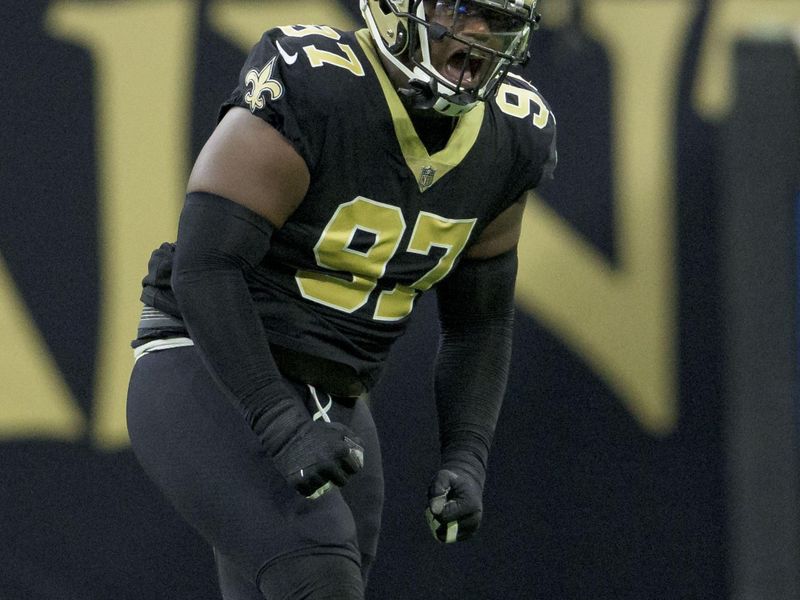 New Orleans Saints defensive end Malcolm Roach (97) celebrates a stop on third down against the Las Vegas Raiders during the first half an NFL football game in New Orleans, Sunday, Oct. 30, 2022. (AP Photo/Matthew Hinton)