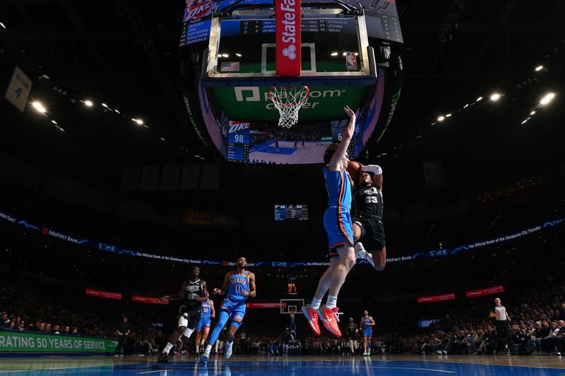 OKLAHOMA CITY, OK - APRIL 10:  Tre Jones #33 of the San Antonio Spurs drives to the basket during the game against the Oklahoma City Thunder on April 10, 2024 at Paycom Arena in Oklahoma City, Oklahoma. NOTE TO USER: User expressly acknowledges and agrees that, by downloading and or using this photograph, User is consenting to the terms and conditions of the Getty Images License Agreement. Mandatory Copyright Notice: Copyright 2024 NBAE (Photo by Zach Beeker/NBAE via Getty Images)