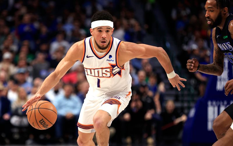 DALLAS, TX - FEBRUARY 22: Devin Booker #1 of the Phoenix Suns handles the ball as Derrick Jones Jr. #55 of the Dallas Mavericks defends in the first half at American Airlines Center on February 22, 2024 in Dallas, Texas. NOTE TO USER: User expressly acknowledges and agrees that, by downloading and or using this photograph, User is consenting to the terms and conditions of the Getty Images License Agreement. (Photo by Ron Jenkins/Getty Images)