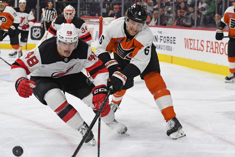 Jan 27, 2025; Philadelphia, Pennsylvania, USA; New Jersey Devils left win Brian Halonen (48) and Philadelphia Flyers defenseman Travis Sanheim (6) battle for the puck during the third period at Wells Fargo Center. Mandatory Credit: Eric Hartline-Imagn Images