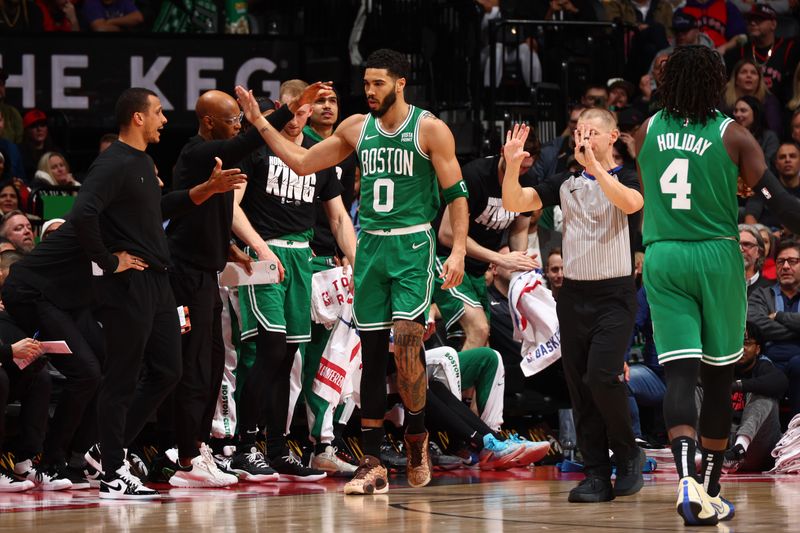 TORONTO, CANADA - JANUARY 15:  Jayson Tatum #0 of the Boston Celtics is congratulated during the game against the Toronto Raptors on January 15, 2024 at the Scotiabank Arena in Toronto, Ontario, Canada.  NOTE TO USER: User expressly acknowledges and agrees that, by downloading and or using this Photograph, user is consenting to the terms and conditions of the Getty Images License Agreement.  Mandatory Copyright Notice: Copyright 2024 NBAE (Photo by Vaughn Ridley/NBAE via Getty Images)