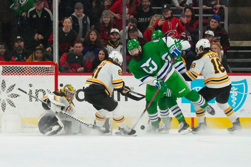 Mar 26, 2023; Raleigh, North Carolina, USA;  Boston Bruins goaltender Jeremy Swayman (1) and defenseman Dmitry Orlov (81) stop the scoring attempt by Carolina Hurricanes defenseman Brent Burns (8) in the overtime at PNC Arena. Mandatory Credit: James Guillory-USA TODAY Sports