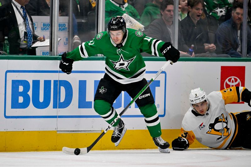 Mar 22, 2024; Dallas, Texas, USA; Dallas Stars center Logan Stankoven (11) skates with puck away from Pittsburgh Penguins defenseman Jack St. Ivany (3) during the second period at the American Airlines Center. Mandatory Credit: Jerome Miron-USA TODAY Sports