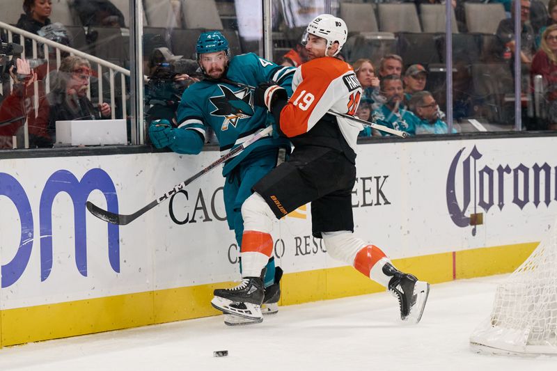 Nov 7, 2023; San Jose, California, USA; Philadelphia Flyers right wing Garnet Hathaway (19) checks San Jose Sharks defenseman Kyle Burroughs (4) into the board during the first period at SAP Center at San Jose. Mandatory Credit: Robert Edwards-USA TODAY Sports