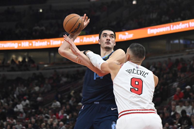 CHICAGO, ILLINOIS - OCTOBER 12: Zach Edey #14 of the Memphis Grizzlies is fouled in the second half of a preseason game against Nikola Vucevic #9 of the Chicago Bulls at the United Center on October 12, 2024 in Chicago, Illinois. NOTE TO USER: User expressly acknowledges and agrees that, by downloading and or using this photograph, User is consenting to the terms and conditions of the Getty Images License Agreement. (Photo by Quinn Harris/Getty Images)