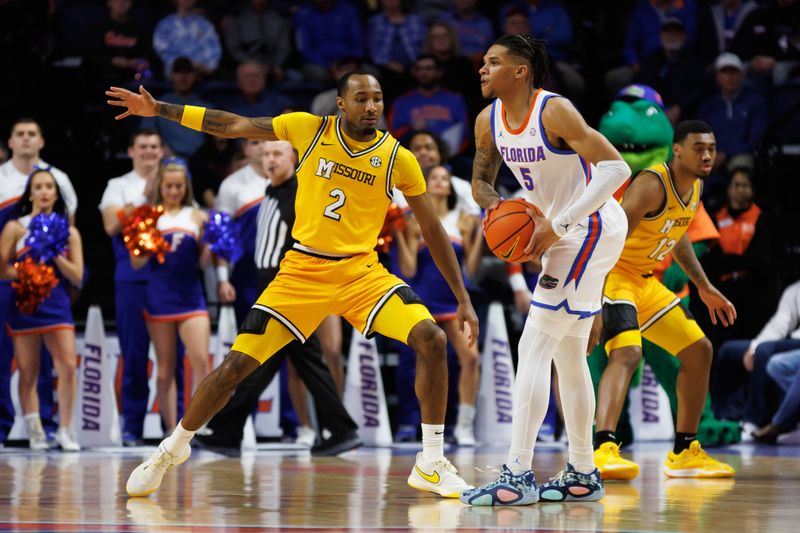 Jan 14, 2025; Gainesville, Florida, USA; Missouri Tigers guard Tamar Bates (2) defends Florida Gators guard Will Richard (5) during the first half at the Stephen C. O'Connell Center in Gainesville, FL on Tuesday, January 14, 2025. Mandatory Credit: Matt Pendleton-Imagn Images