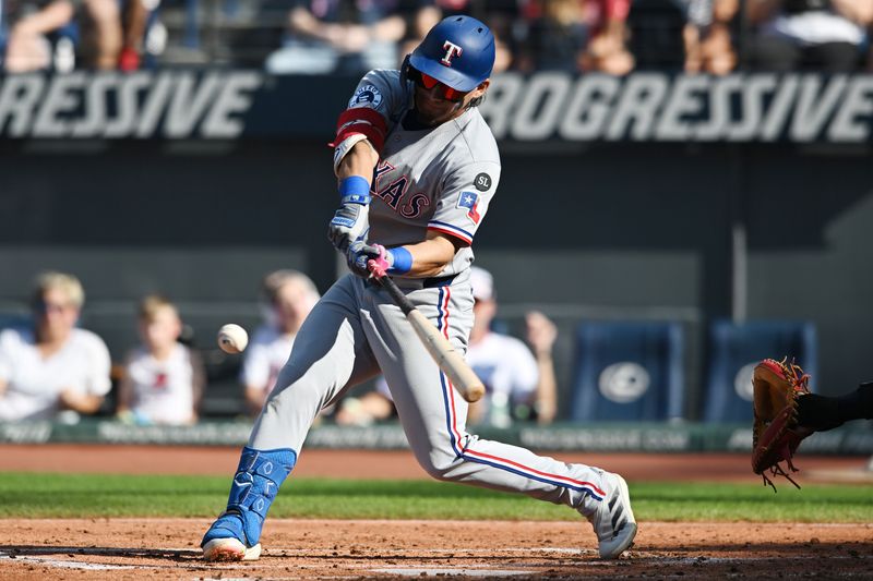 Sep 28, 2025; Cleveland, Ohio, USA;  Texas Rangers left fielder Alejandro Osuna (19) hits an RBI double during the second inning against the Cleveland Guardians at Progressive Field. Mandatory Credit: Ken Blaze-Imagn Images