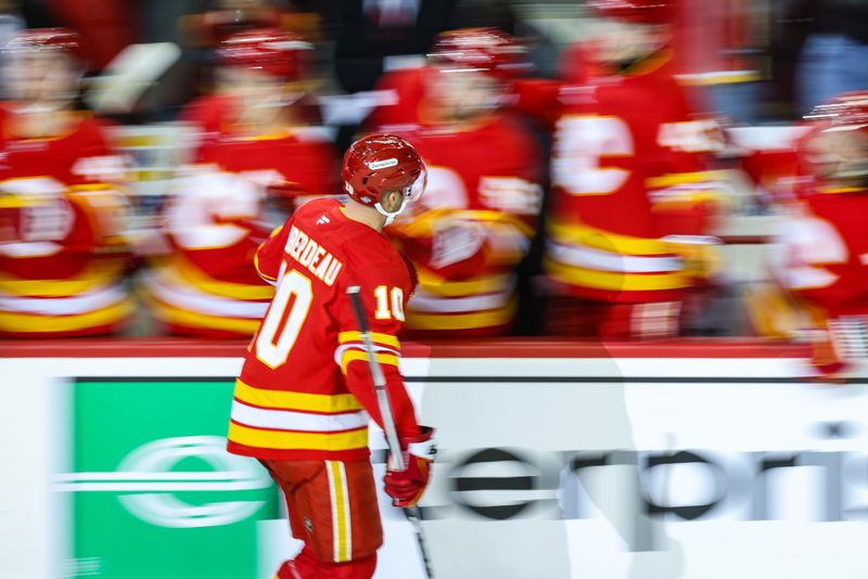 Oct 12, 2024; Calgary, Alberta, CAN; Calgary Flames center Jonathan Huberdeau (10) celebrates his goal with teammates against the Philadelphia Flyers during the first period at Scotiabank Saddledome. Mandatory Credit: Sergei Belski-Imagn Images