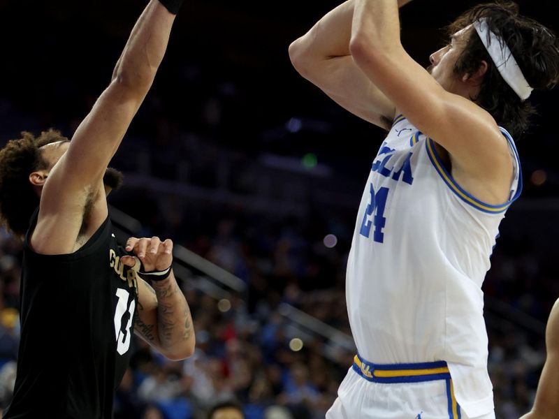 Jan 14, 2023; Los Angeles, California, USA; UCLA Bruins guard Jaime Jaquez Jr. (24) shoots the ball against Colorado Buffaloes guard J'Vonne Hadley (13) during the second half at Pauley Pavilion presented by Wescom. Mandatory Credit: Kiyoshi Mio-USA TODAY Sports