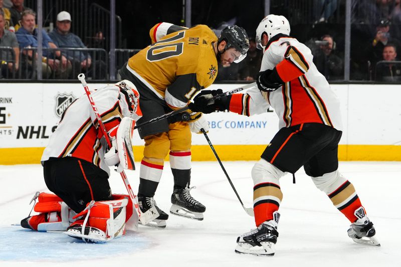 Apr 18, 2024; Las Vegas, Nevada, USA; Anaheim Ducks goaltender Lukas Dostal (1) protects his net while an incoming shot deflects off of Vegas Golden Knights center Nicolas Roy (10) as Anaheim Ducks defenseman Radko Gudas (7) joins the play during the second period at T-Mobile Arena. Mandatory Credit: Stephen R. Sylvanie-USA TODAY Sports