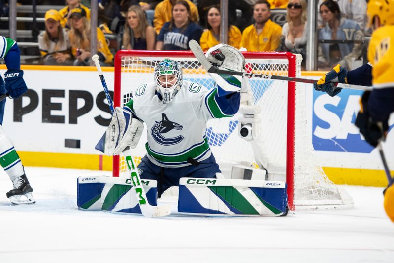 May 3, 2024; Nashville, Tennessee, USA; Vancouver Canucks goalkeeper Vancouver Canucks goalie Arturs Silovs (31) blocks the puck against the Nashville Predators during the third period in game six of the first round of the 2024 Stanley Cup Playoffs at Bridgestone Arena. Mandatory Credit: Steve Roberts-USA TODAY Sports