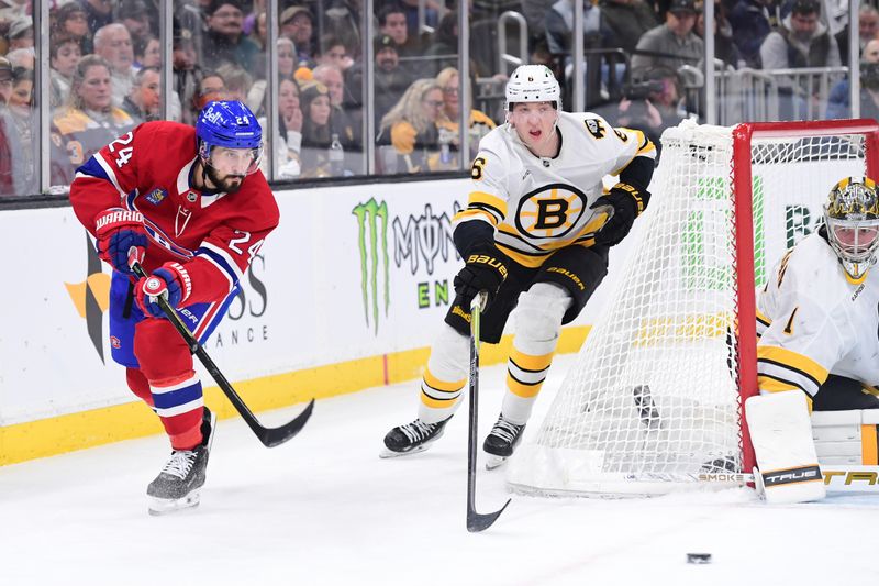 Jan 24, 2026; Boston, Massachusetts, USA; Montreal Canadiens center Phillip Danault (24) passes the puck ahead of Boston Bruins defenseman Mason Lohrei (6) during the second period at TD Garden. Mandatory Credit: Bob DeChiara-Imagn Images