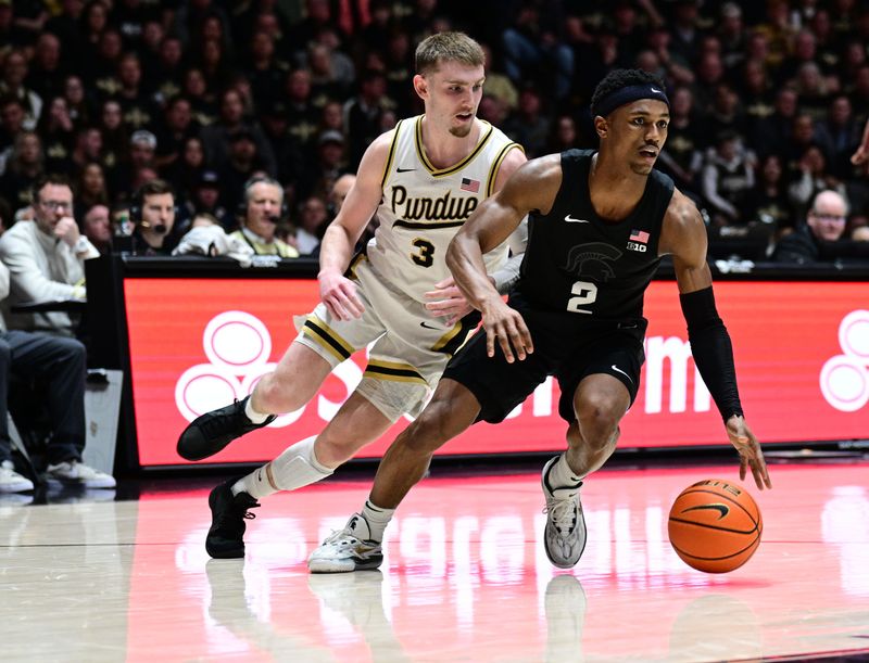 Mar 2, 2024; West Lafayette, Indiana, USA; Michigan State Spartans guard Tyson Walker (2) drives the ball past Purdue Boilermakers guard Braden Smith (3) during the first half at Mackey Arena. Mandatory Credit: Marc Lebryk-USA TODAY Sports