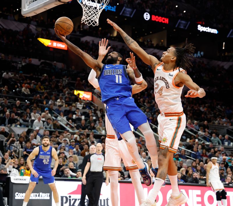 SAN ANTONIO, TX - MARCH 19:  Kyrie Irving #11 of the Dallas Mavericks drives past Devin Vassell #24 of the San Antonio Spurs in the second half at Frost Bank Center on March 19, 2024 in San Antonio, Texas. NOTE TO USER: User expressly acknowledges and agrees that, by downloading and or using this photograph, User is consenting to terms and conditions of the Getty Images License Agreement. (Photo by Ronald Cortes/Getty Images)