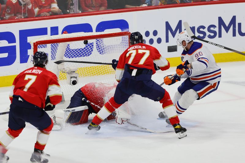 Jun 18, 2024; Sunrise, Florida, USA; Edmonton Oilers forward Corey Perry (90) scores against Florida Panthers goaltender Sergei Bobrovsky (72) and defenseman Niko Mikkola (77) during the second period in game five of the 2024 Stanley Cup Final at Amerant Bank Arena. Mandatory Credit: Sam Navarro-USA TODAY Sports