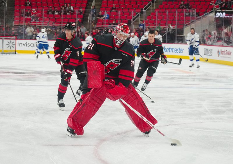 Oct 11, 2024; Raleigh, North Carolina, USA;  Carolina Hurricanes goaltender Frederik Andersen (31) skates with the puck during the warmups before the game against the Tampa Bay Lightning at PNC Arena. Mandatory Credit: James Guillory-Imagn Images