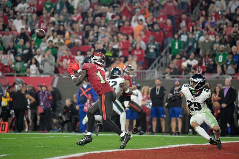 Tampa Bay Buccaneers wide receiver Chris Godwin (14) scores a touchdown on a pass play as Philadelphia Eagles cornerback Avonte Maddox (29) watches during the second half of an NFL wild-card playoff football game, Monday, Jan. 15, 2024, in Tampa, Fla. (AP Photo/Phelan M. Ebenhack)