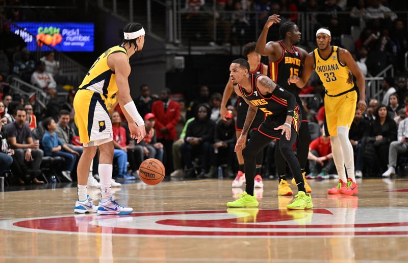 ATLANTA, GEORGIA - JANUARY 12: Dejounte Murray #5 (R) plays defense against Andrew Nembhard #2 of the Indiana Pacers during the game between the Indiana Pacers and the Atlanta Hawks on January 12, 2024 at State Farm Arena in Atlanta, Georgia.  NOTE TO USER: User expressly acknowledges and agrees that, by downloading and or using this photograph, User is consenting to the terms and conditions of the Getty Images License Agreement. (Photo by Paras Griffin/Getty Images)