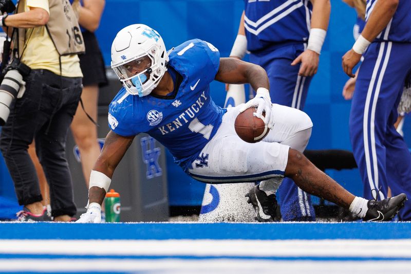 Sep 9, 2023; Lexington, Kentucky, USA; Kentucky Wildcats running back Ray Davis (1) slides into the end zone for a touchdown during the fourth quarter against the Eastern Kentucky Colonels at Kroger Field. Mandatory Credit: Jordan Prather-USA TODAY Sports