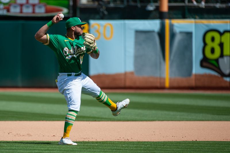 Apr 29, 2023; Oakland, California, USA; Oakland Athletics second baseman Jordan Diaz (13) throws to first base during the seventh inning against the Cincinnati Reds at RingCentral Coliseum. Mandatory Credit: Ed Szczepanski-USA TODAY Sports