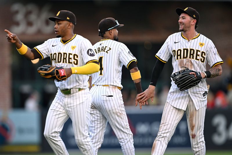 Jun 22, 2024; San Diego, California, USA; San Diego Padres center fielder Jackson Merrill (right) and first baseman Luis Arraez (4) celebrate on the field after defeating the Milwaukee Brewers at Petco Park. Mandatory Credit: Orlando Ramirez-USA TODAY Sports