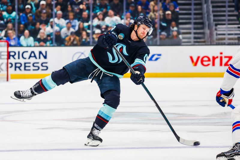 Nov 17, 2024; Seattle, Washington, USA; Seattle Kraken left wing Jared McCann (19) shoots the puck against the New York Rangers during the first period at Climate Pledge Arena. Mandatory Credit: Joe Nicholson-Imagn Images