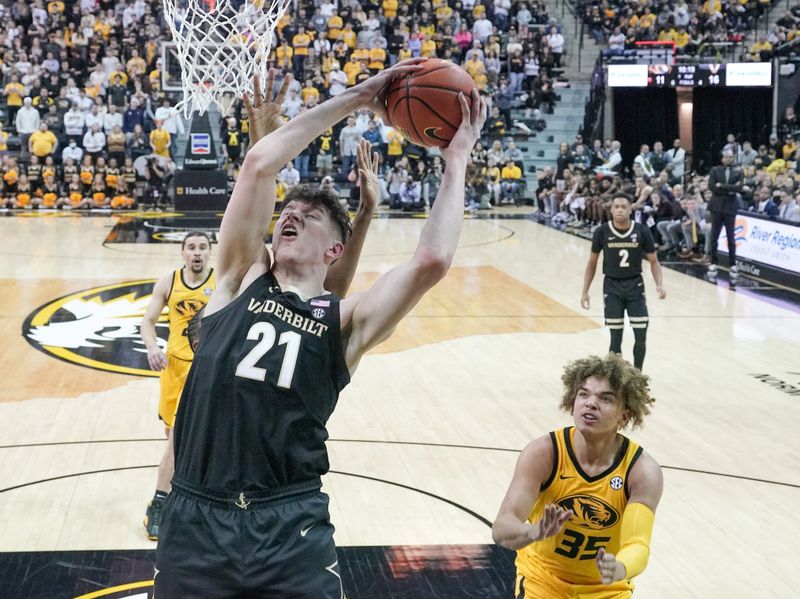 Jan 7, 2023; Columbia, Missouri, USA; Vanderbilt Commodores forward Liam Robbins (21) shoots as Missouri Tigers forward Noah Carter (35) looks on during the first half at Mizzou Arena. Mandatory Credit: Denny Medley-USA TODAY Sports